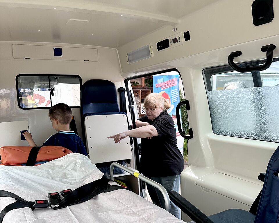 kind sieht sich Rettungswagen an